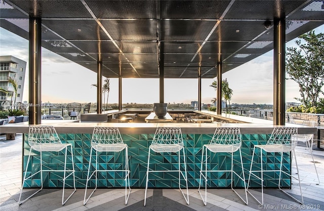 patio terrace at dusk featuring exterior bar