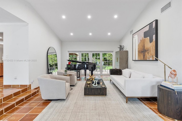 living room featuring tile patterned floors, high vaulted ceiling, and french doors