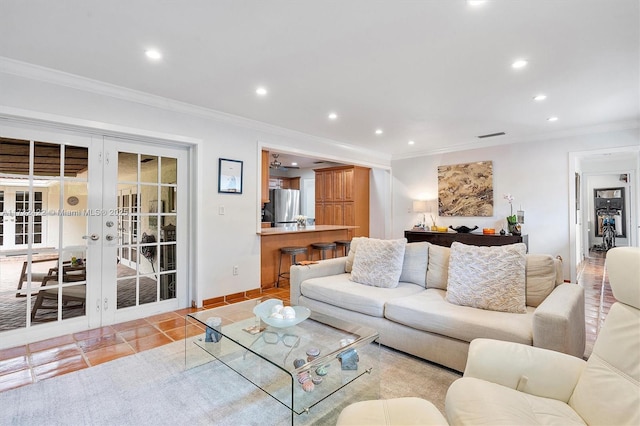 tiled living room featuring ornamental molding and french doors