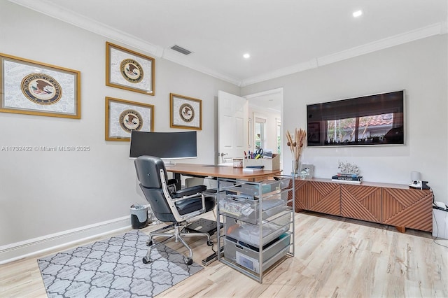 office with light hardwood / wood-style flooring and ornamental molding