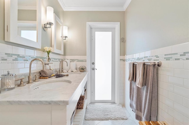 bathroom with tile patterned floors, ornamental molding, tile walls, and vanity