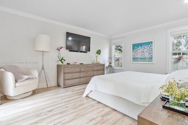 bedroom with ornamental molding and light hardwood / wood-style floors