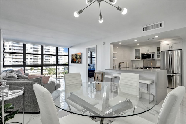 dining space featuring floor to ceiling windows