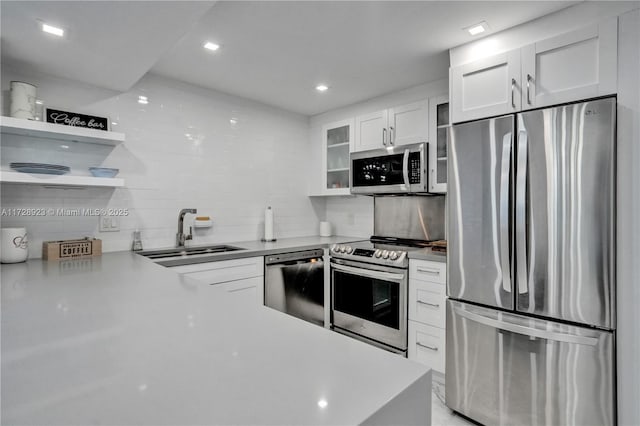 kitchen with white cabinetry, sink, tasteful backsplash, and appliances with stainless steel finishes