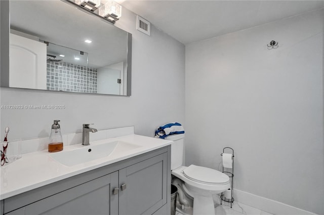 bathroom with vanity, toilet, and walk in shower