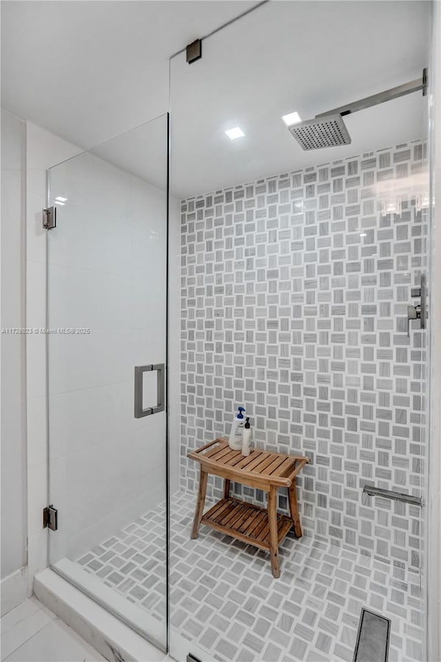 bathroom with a shower with door