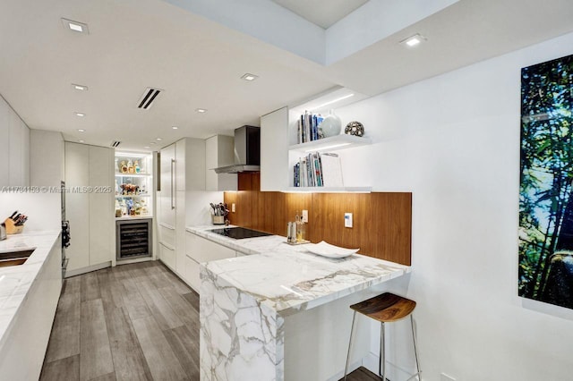 1121 Crandon Blvd Unit D706, Key Biscayne, FL 33149 - kitchen featuring wall chimney range hood, open shelves, beverage cooler, modern cabinets, and light stone countertops