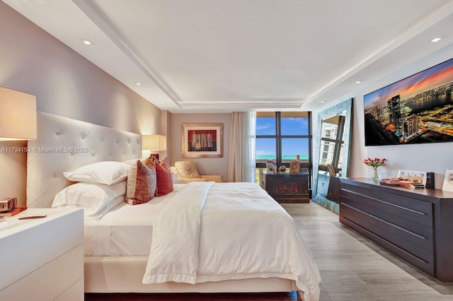 1121 Crandon Blvd Unit D706, Key Biscayne, FL 33149 - bedroom featuring a tray ceiling, recessed lighting, and light wood-style floors