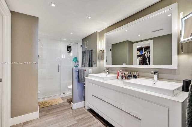 1121 Crandon Blvd Unit D706, Key Biscayne, FL 33149 - bathroom with a shower stall, toilet, wood finished floors, and a sink