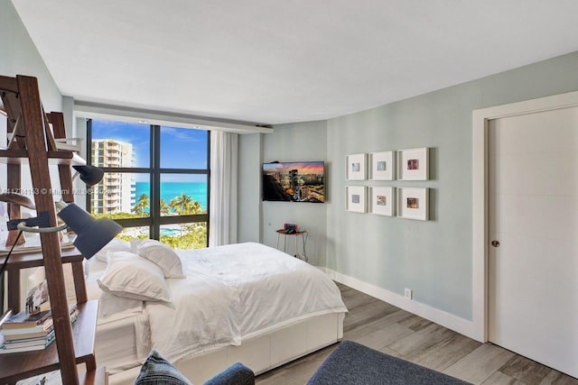 1121 Crandon Blvd Unit D706, Key Biscayne, FL 33149 - bedroom with expansive windows, wood finished floors, and baseboards