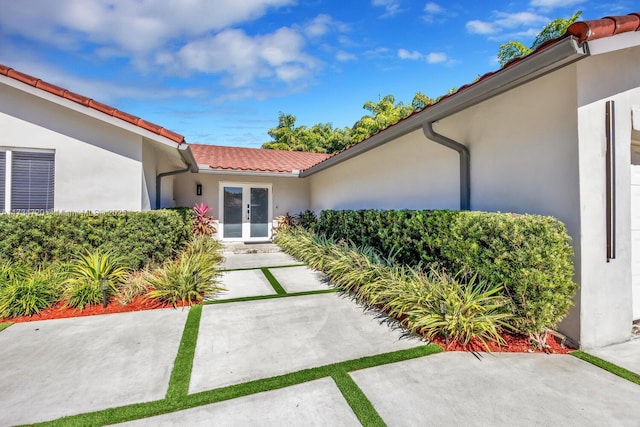 property entrance featuring french doors and a patio area