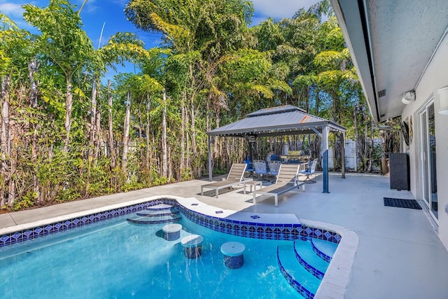 view of swimming pool featuring a gazebo and a patio