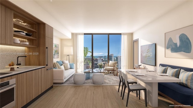 living room with expansive windows, sink, and light hardwood / wood-style floors