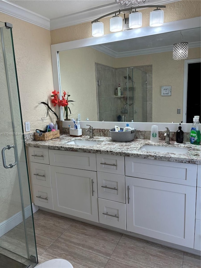 bathroom featuring ornamental molding, a shower with shower door, and vanity