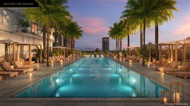 pool at dusk with a patio