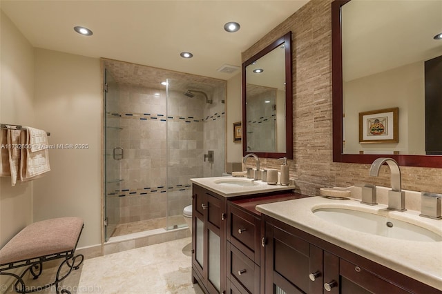 bathroom featuring vanity, an enclosed shower, and backsplash