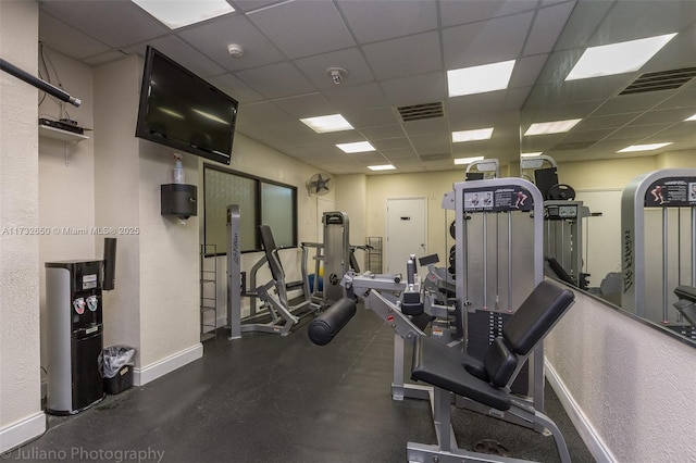 exercise room featuring a drop ceiling