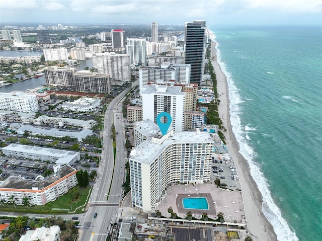 drone / aerial view with a water view and a beach view