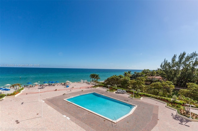 view of swimming pool featuring a water view