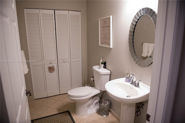 bathroom featuring sink, tile patterned floors, and toilet