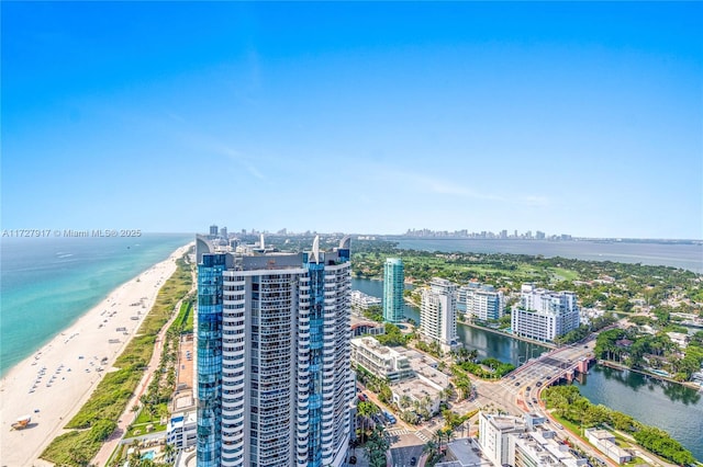 birds eye view of property with a water view and a view of the beach