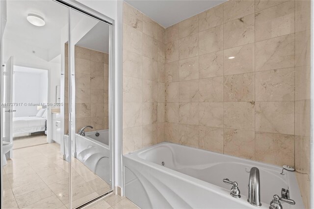 bathroom with tile patterned flooring and a bathtub