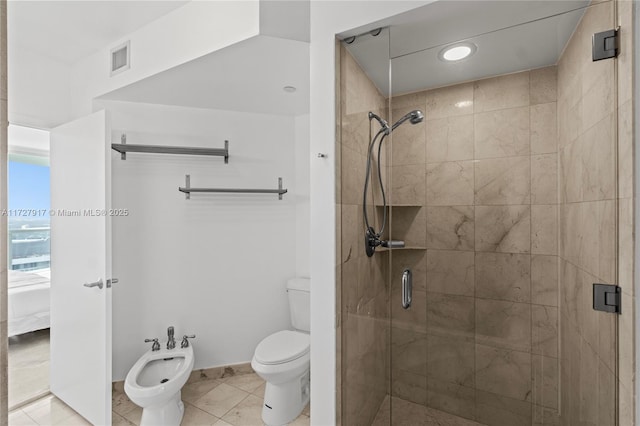 bathroom featuring a bidet, tile patterned flooring, a shower with shower door, and toilet