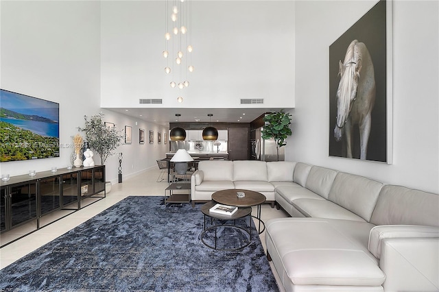 living room featuring a high ceiling and tile patterned flooring