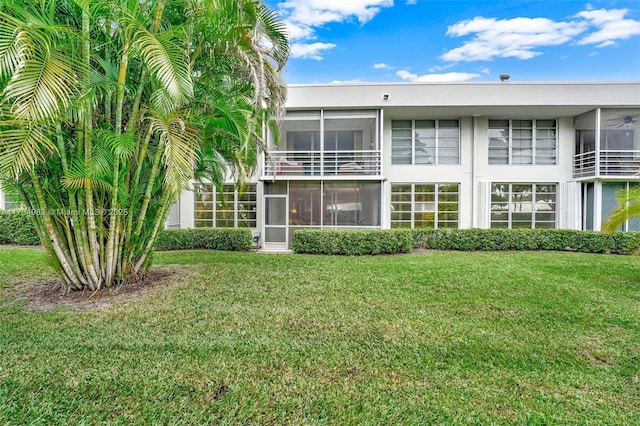 rear view of house with a lawn