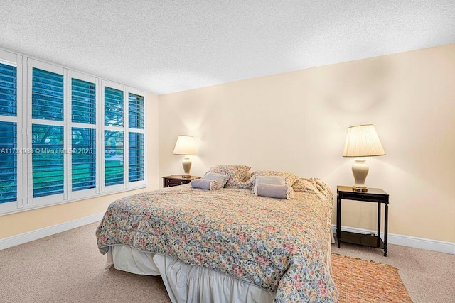 bedroom featuring light colored carpet and a textured ceiling