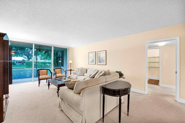 living room featuring expansive windows, light colored carpet, and a textured ceiling