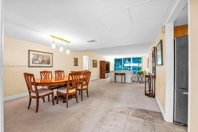 dining room featuring light colored carpet