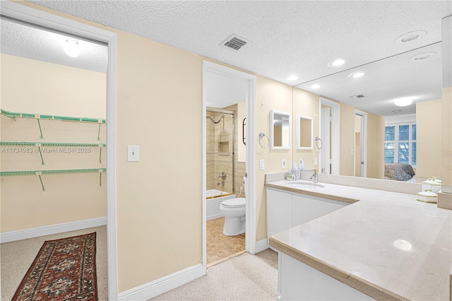 full bathroom featuring vanity, combined bath / shower with glass door, a textured ceiling, and toilet