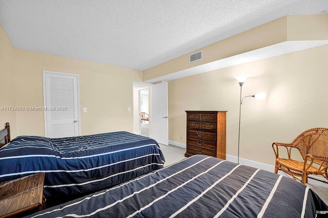 carpeted bedroom with a textured ceiling