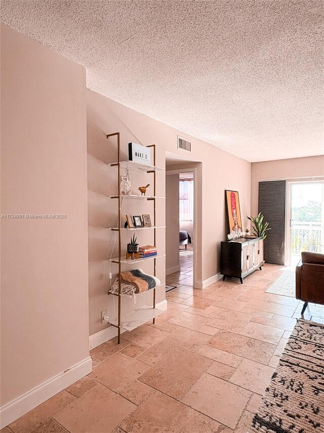 corridor with a textured ceiling