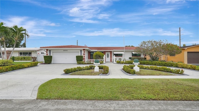 single story home featuring a garage and a front lawn