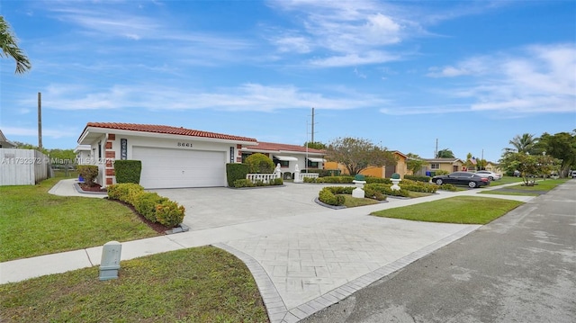 single story home featuring a garage and a front yard