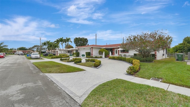 view of front of home featuring a garage and a front yard