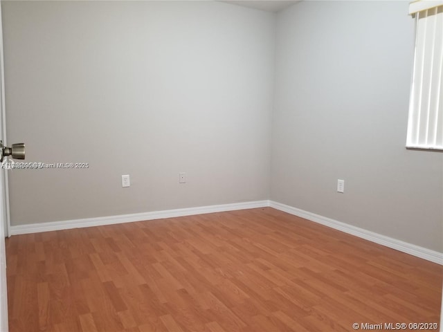 spare room featuring light wood-type flooring