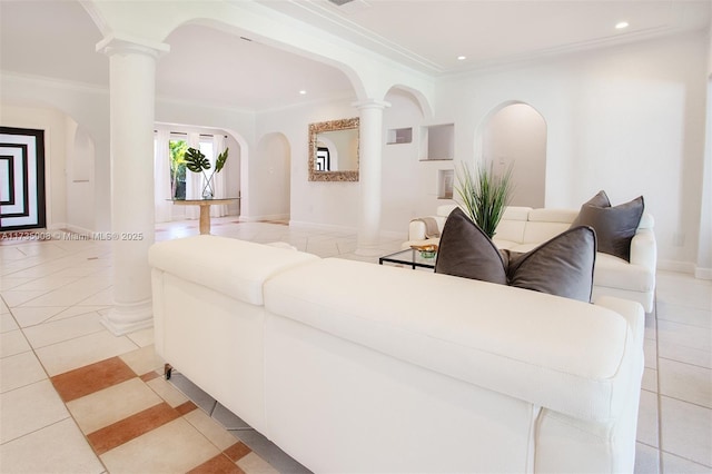 living room featuring crown molding, decorative columns, and light tile patterned flooring