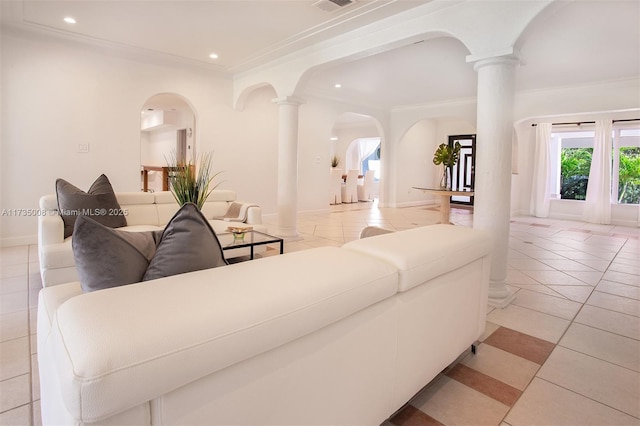 living room with light tile patterned flooring, ornamental molding, and ornate columns