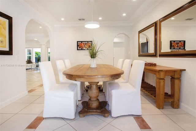 tiled dining area featuring ornamental molding