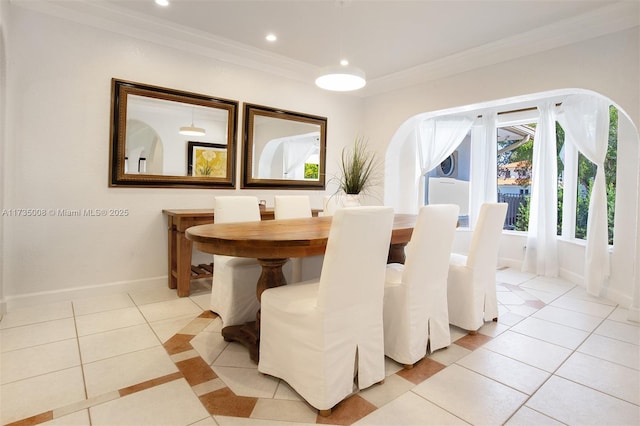 dining room featuring crown molding and light tile patterned floors