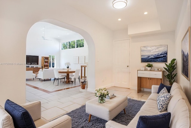 living room featuring light tile patterned floors and ceiling fan