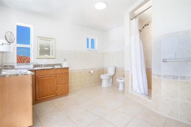 bathroom featuring tile walls, tile patterned flooring, vanity, walk in shower, and toilet