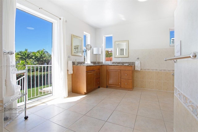 bathroom featuring tile patterned floors, vanity, and tile walls