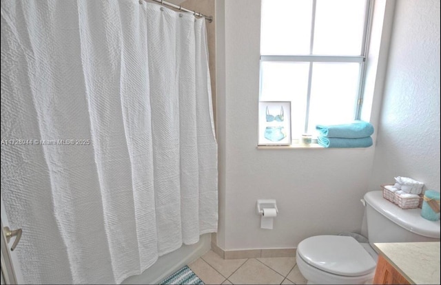 bathroom featuring tile patterned flooring, vanity, and toilet