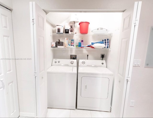 laundry area with light tile patterned floors and independent washer and dryer