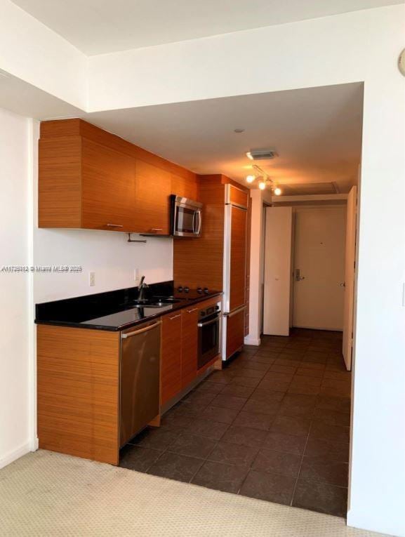 50 Biscayne Blvd Unit 4609, Miami, FL 33132 - kitchen featuring stainless steel appliances, sink, and dark tile patterned floors