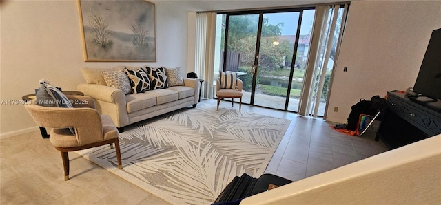 living room featuring expansive windows, plenty of natural light, and baseboards